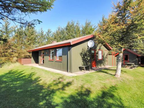 a green and red house with a yard at Holiday Home Neven - 900m from the sea by Interhome in Torsted