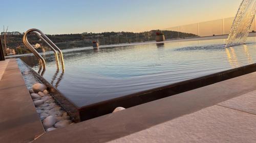 a large swimming pool with a water slide at Private Villa for rent in Māḩiş