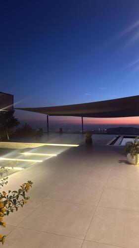 a view of the wing of an airplane at night at Private Villa for rent in Māḩiş