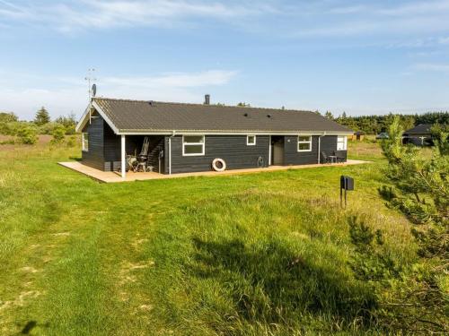a house in a field with a large yard at Holiday Home Sulki - 3-5km from the sea by Interhome in Frøstrup