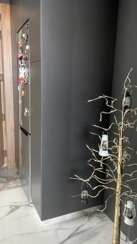 a stainless steel refrigerator with a tree in front of it at Private Villa for rent in Māḩiş