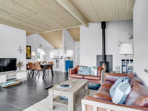 a living room with a couch and a table at Holiday Home Sulki - 3-5km from the sea by Interhome in Frøstrup