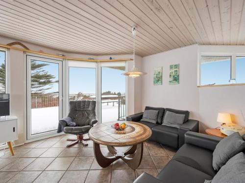 a living room with a couch and a table at Holiday Home Ginny - 300m to the fjord by Interhome in Struer