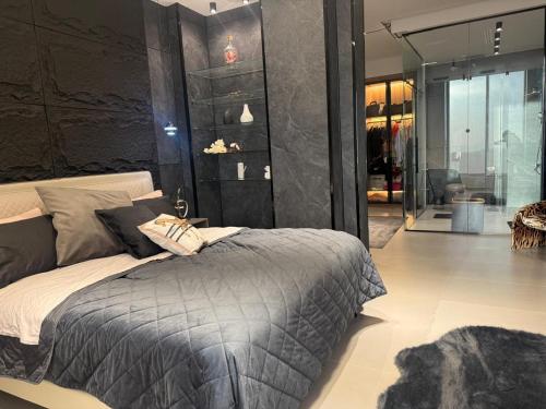 a bedroom with a large bed and a room with a glass door at Private Villa for rent in Māḩiş