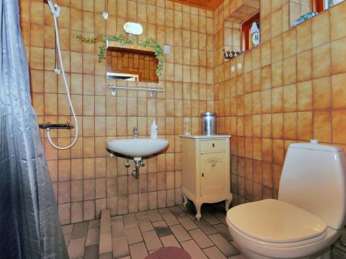 a bathroom with a toilet and a sink at Holiday Home Palle - 2km from the sea by Interhome in Snedsted