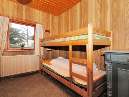 a bedroom with two bunk beds and a window at Holiday Home Palle - 2km from the sea by Interhome in Snedsted