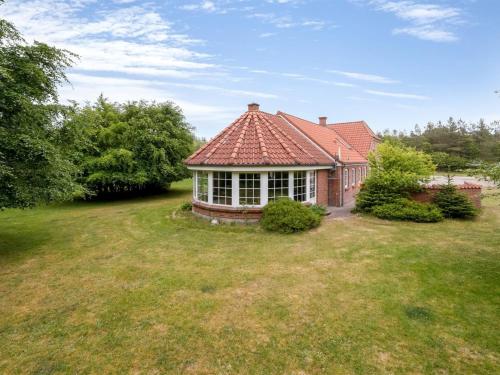 a house with a red roof on a yard at Holiday Home Wilmar - 1km to the fjord by Interhome in Vemb