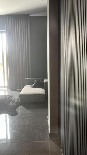 a bedroom with a bed in a room with a window at Private Villa for rent in Māḩiş