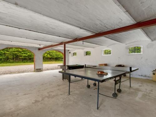 a ping pong table sitting inside of a building at Holiday Home Wilmar - 1km to the fjord by Interhome in Vemb