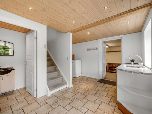 a kitchen with a staircase in a house at Holiday Home Wilmar - 1km to the fjord by Interhome in Vemb