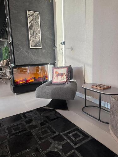 a living room with a chair and a table at Private Villa for rent in Māḩiş