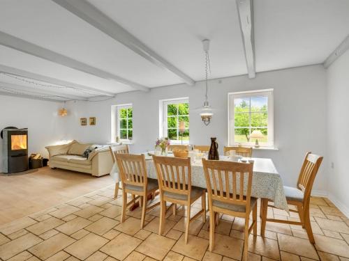 a kitchen and living room with a table and chairs at Holiday Home Wilmar - 1km to the fjord by Interhome in Vemb