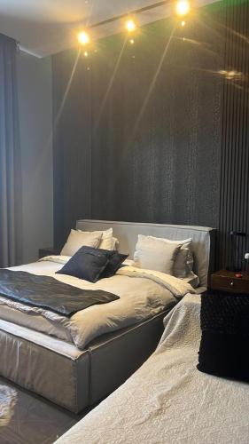a large bed in a room with lights above it at Private Villa for rent in Māḩiş