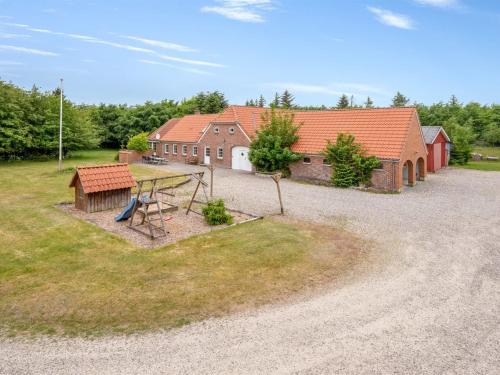 an aerial view of a house with a playground at Holiday Home Wilmar - 1km to the fjord by Interhome in Vemb