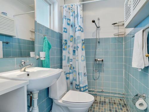 a bathroom with a sink and a toilet and a shower at Apartment Gerwendil - 500m to the fjord by Interhome in Øsløs