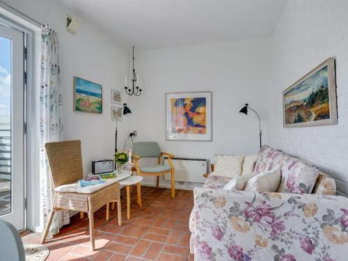 a living room with a couch and a table at Apartment Gerwendil - 500m to the fjord by Interhome in Øsløs