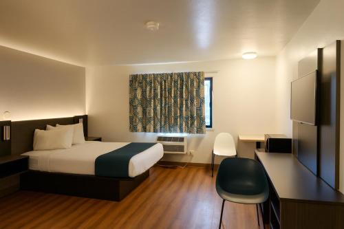 a hotel room with a bed and a window at Motel 6-Duluth, MN in Duluth