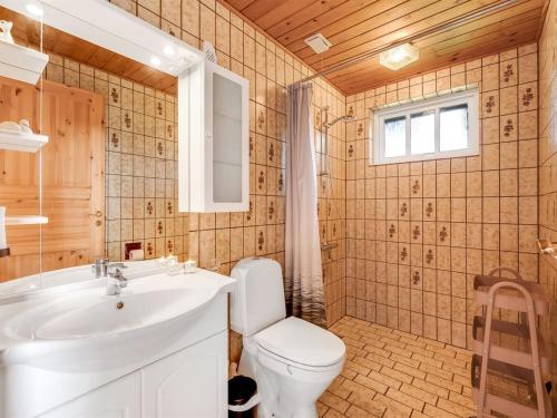 a bathroom with a white toilet and a sink at Holiday Home Tuki - 700m to the fjord by Interhome in Struer