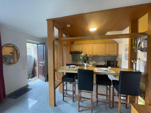 a kitchen with a large wooden table and chairs at Fewo 2 EG Sylt Westerland in Süderende