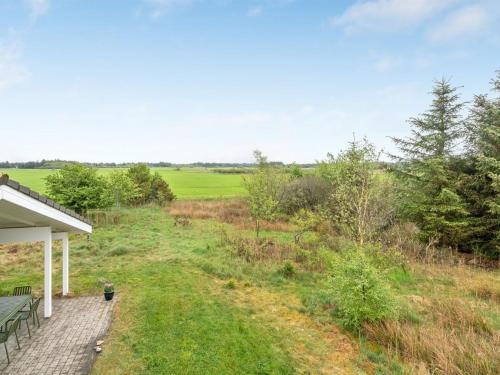 a view of a field from the porch of a house at Holiday Home Aameek - 3km from the sea by Interhome in Frøstrup