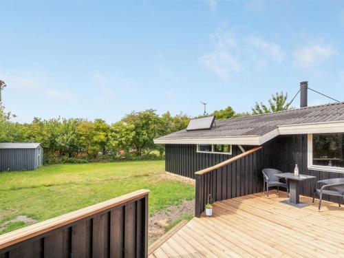 a deck with a table and chairs on a house at Holiday Home Dali - 400m to the fjord by Interhome in Vestervig