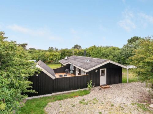 a black house with a pitched roof at Holiday Home Dali - 400m to the fjord by Interhome in Vestervig