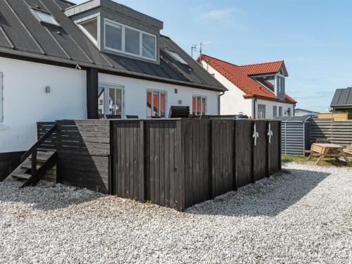 a wooden fence in front of a house at Holiday Home Thilla - 100m from the sea by Interhome in Thisted