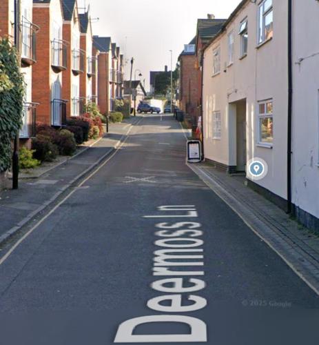 an empty street with a sign that says addiction at The Whitchurch Apartment- The Painted Rooms in Whitchurch
