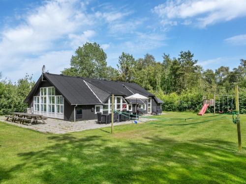 a house with a playground in the yard at Holiday Home Eisa - 300m to the fjord by Interhome in Øsløs