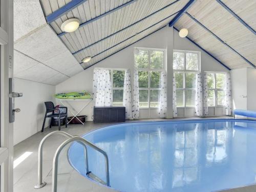 a swimming pool in a room with a ceiling at Holiday Home Eisa - 300m to the fjord by Interhome in Øsløs