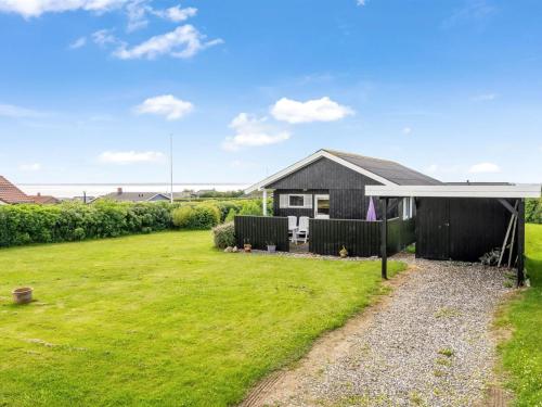 a house with a large yard in front of it at Holiday Home Pavo - 300m to the fjord by Interhome in Vinderup