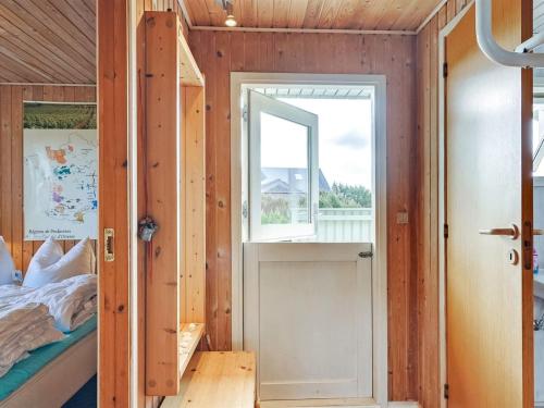 a bedroom with a bed and a window at Holiday Home Pavo - 300m to the fjord by Interhome in Vinderup