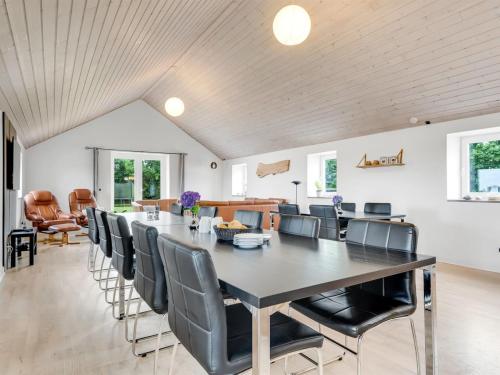 a dining room with a large table and chairs at Holiday Home Folkar - 3km to the fjord by Interhome in Thyholm