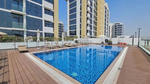 a swimming pool on the roof of a building at StayShort - Meydan Apartment sleeps 4 with a Private Balcony in Dubai