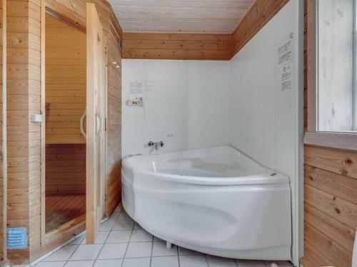 a bathroom with a large white tub and a shower at Holiday Home Bjarnger - 200m from the sea by Interhome in Frøstrup