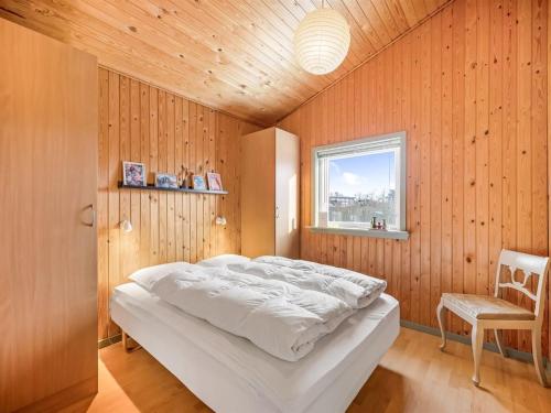 a bedroom with a large bed and a window at Holiday Home Kai - 500m to the fjord by Interhome in Struer