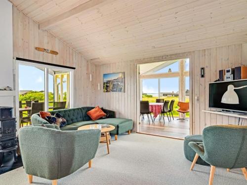 a living room with a green couch and chairs at Holiday Home Titta - 150m to the inlet by Interhome in Vinderup