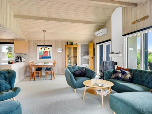 a living room with blue couches and a table at Holiday Home Titta - 150m to the inlet by Interhome in Vinderup