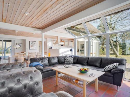 a living room with a couch and a table at Holiday Home Gertrudis - 2km to the fjord by Interhome in Frøstrup