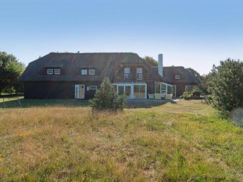 a large house with a grassy field in front of it at Holiday Home Gertrudis - 2km to the fjord by Interhome in Frøstrup