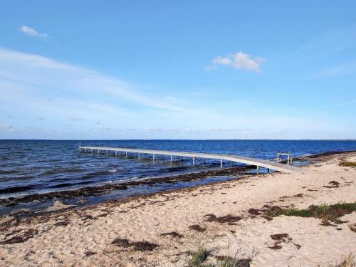 a boardwalk stretches out into the water on a beach at Holiday Home Scarlet - 400m to the inlet by Interhome in Vinderup