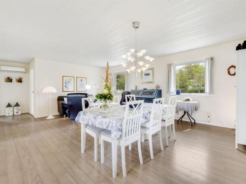 a dining room and living room with a table and chairs at Holiday Home Mikkeline - 400m to the fjord by Interhome in Øster Assels