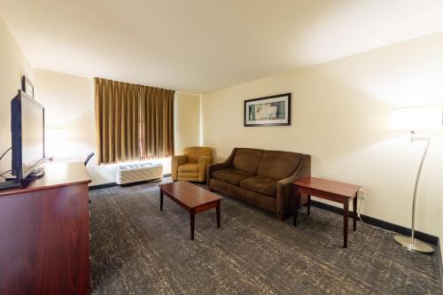 a hotel room with a couch and a tv at Cobblestone Inn and Suites - Eaton in Eaton