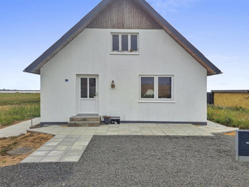 a white house with a front door and a driveway at Holiday Home Thomsen - 200m to the inlet by Interhome in Sønder Dråby