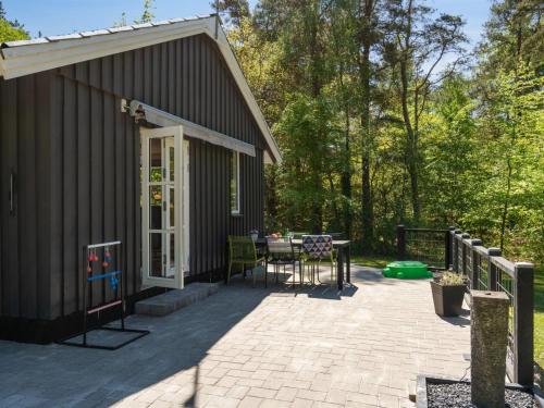 a patio with a table in front of a building at Holiday Home Hunding - 7km from the sea by Interhome in Ebeltoft