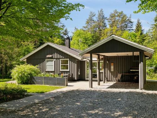 a small house with a gambrel roof at Holiday Home Hunding - 7km from the sea by Interhome in Ebeltoft