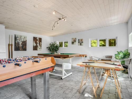 a room with two tables and a pool table at Holiday Home Anine - 200m to the fjord by Interhome in Højslev