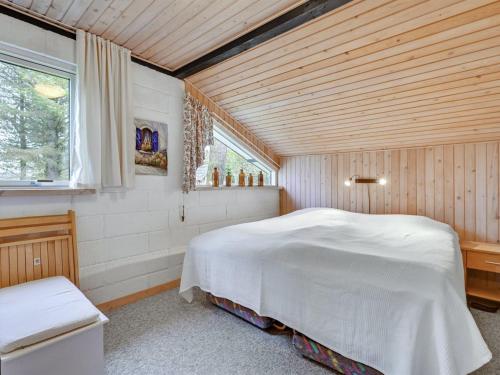 a bedroom with a white bed in a room with a window at Holiday Home Kaleva - 200m to the fjord by Interhome in Fur