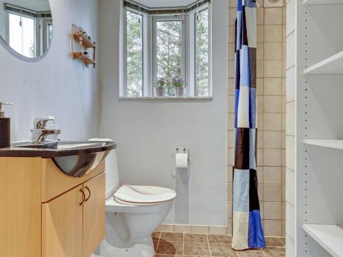 a bathroom with a toilet and a sink at Holiday Home Kaleva - 200m to the fjord by Interhome in Fur