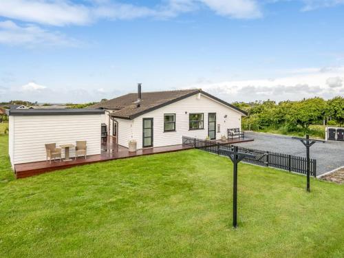 a white house with a deck and grass at Holiday Home Selke - 300m to the fjord by Interhome in Vestervig